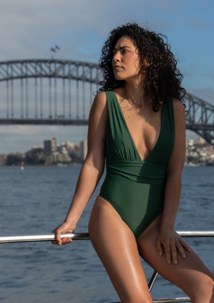 V NECK SEXY GREEN ONE PIECE. AUSTRALIAN MADE SWIMWEAR. SWIMWEAR MODEL HARBOUR BRIDGE SYDNEY. SKIMS SEXY ONE PIECE 